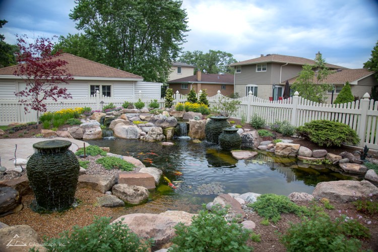 Ecosystem fish pond with beach area plants and fountains